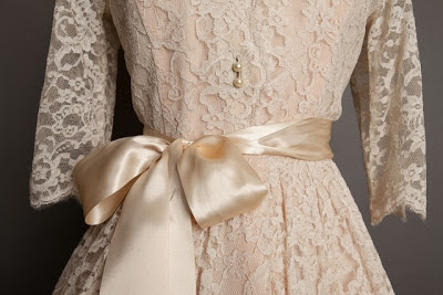 A guide to vintage lace wedding dresses, detail of bodice of classic 1950s lace wedding dress with satin ribbon belt